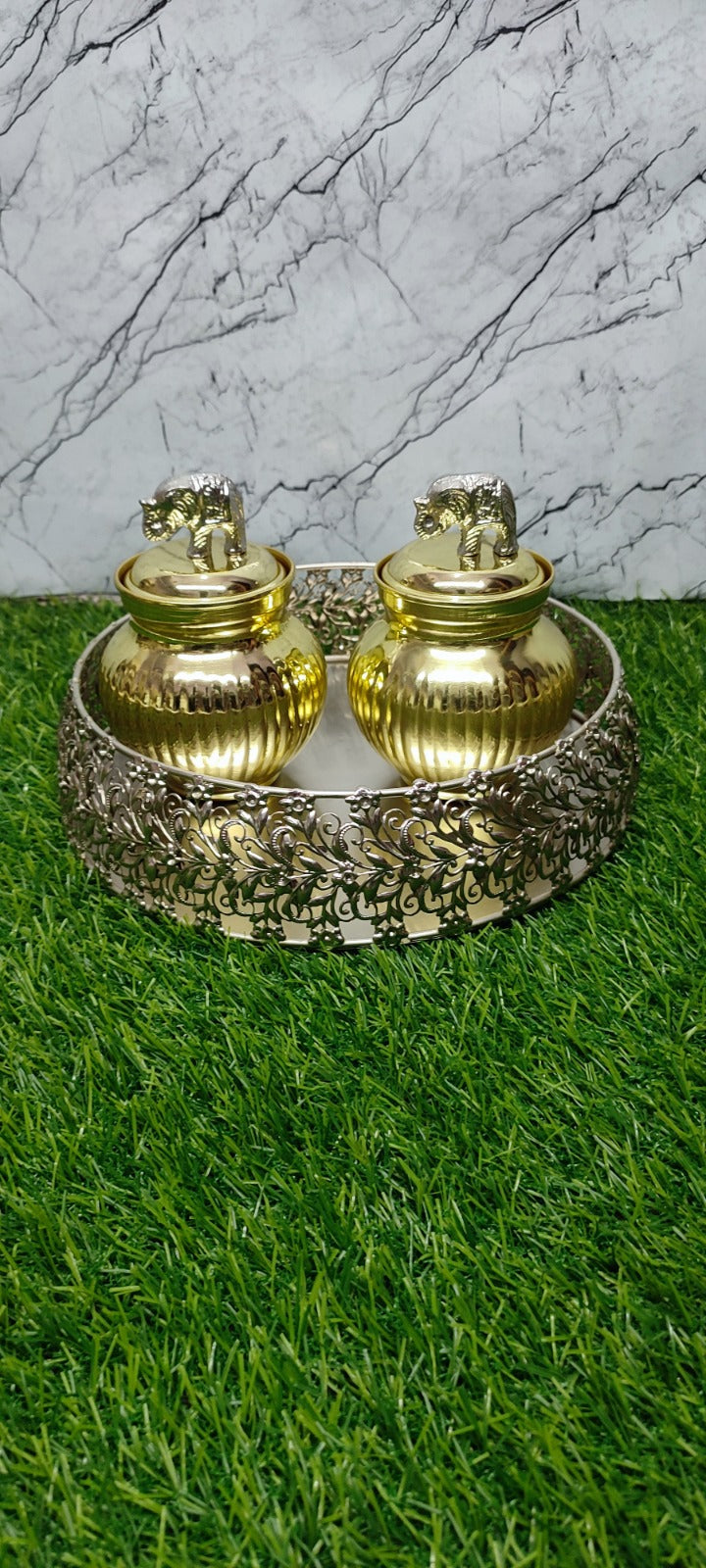 Silver tray with golden jar