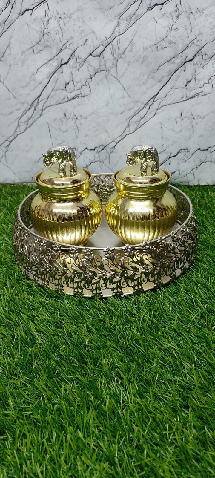 Silver tray with golden jar